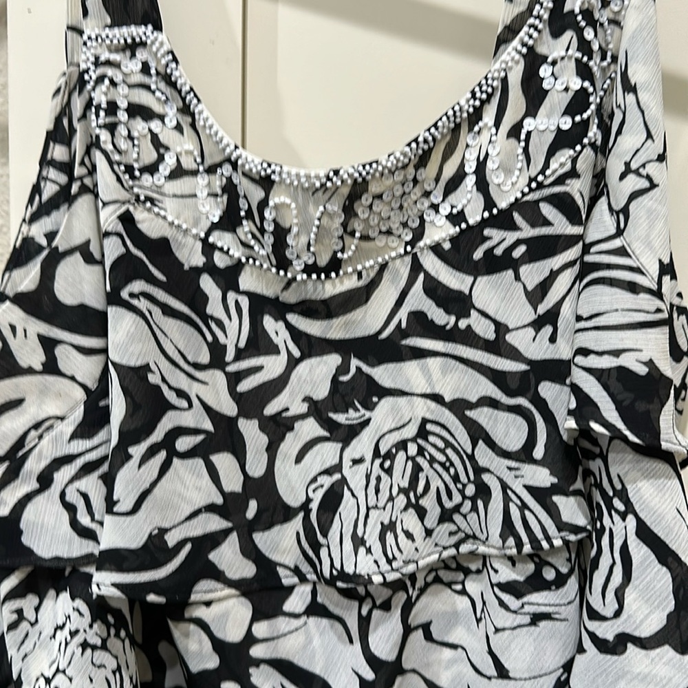 Lane Bryant top. sequin embellishment at top. Ruffles down the top.